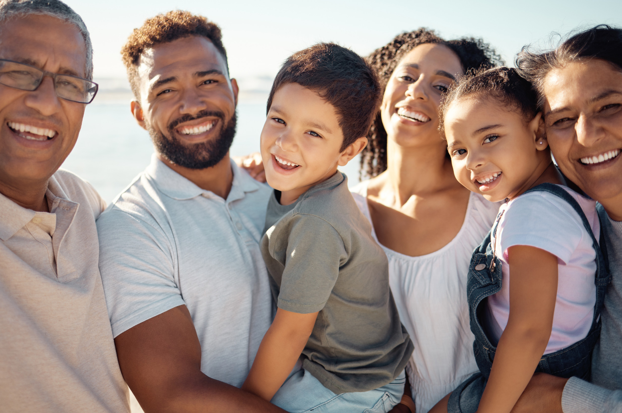 Diversity big family in portrait for summer outdoor holiday with children and grandparents on blue sky and sunshine. Happy smile of grandmother, father and kids for wellness, vitamin d or development multi-generation, diverse family smiling with healthy teeth